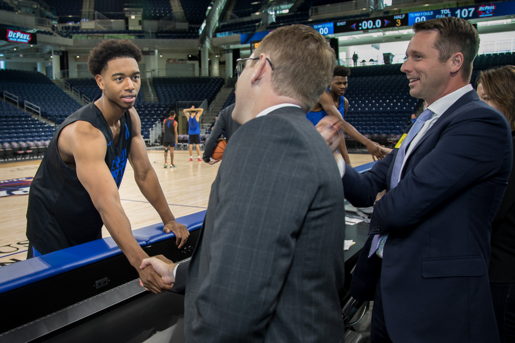 DePaul basketball player Eli Cain, left, greets an attendee. (DePaul University/Jeff Carrion)